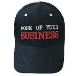 Black cap with 'None of Your Business' text on a white background