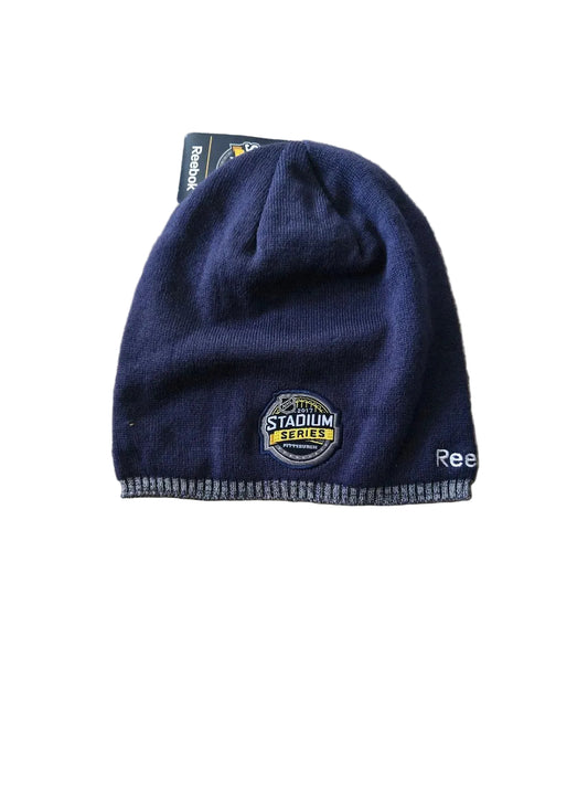 Navy blue knit beanie with a logo on a white background

