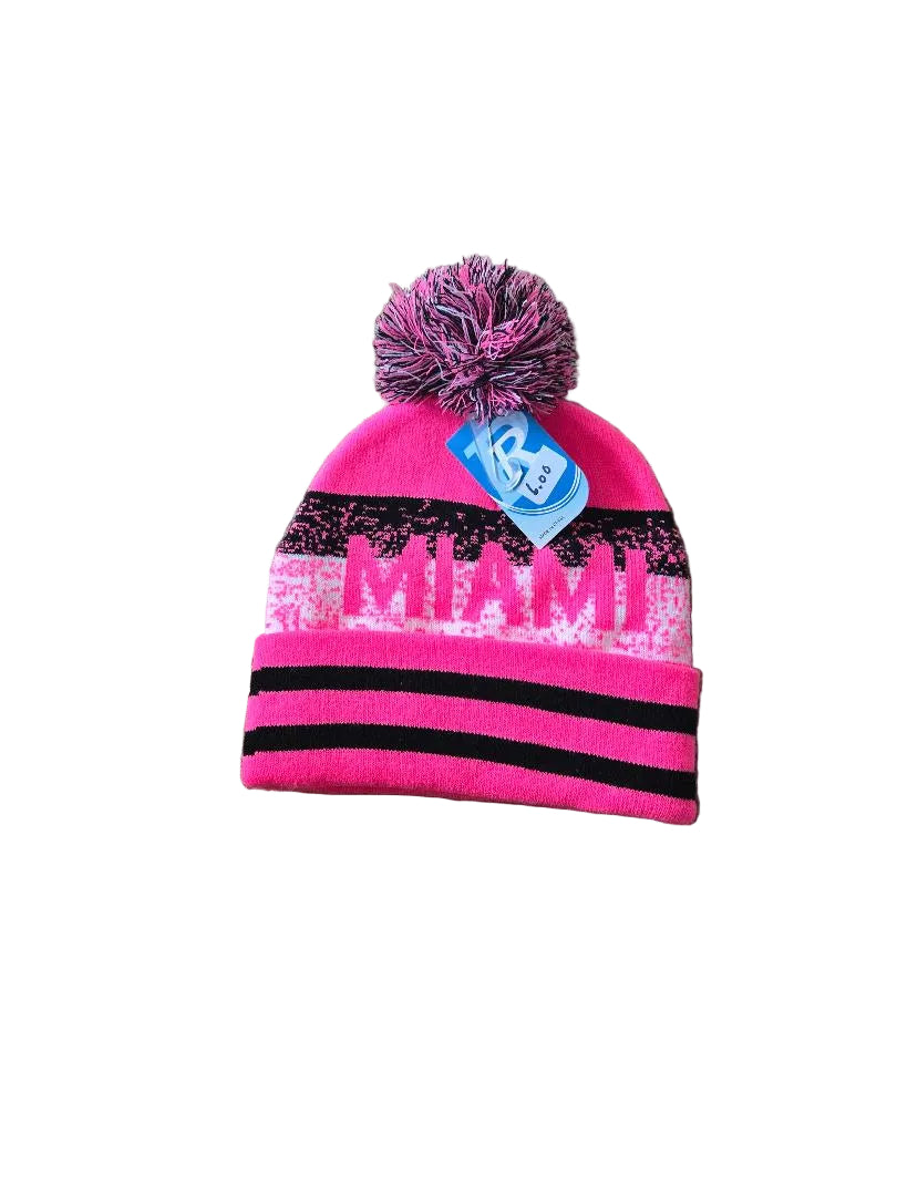 Pink and black beanie with 'MIAMI' on a gray carpet

