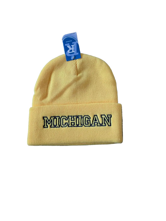 Yellow beanie with 'Michigan' embroidery on a gray surface

