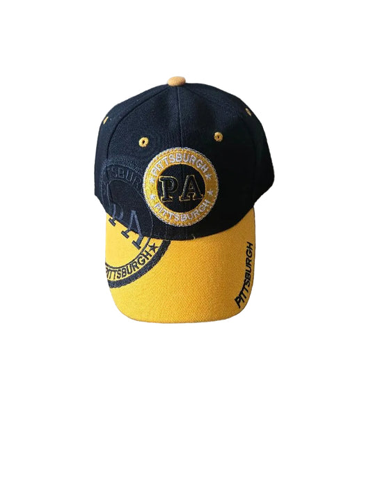 Black and yellow cap with 'PA' logo on a gray carpet

